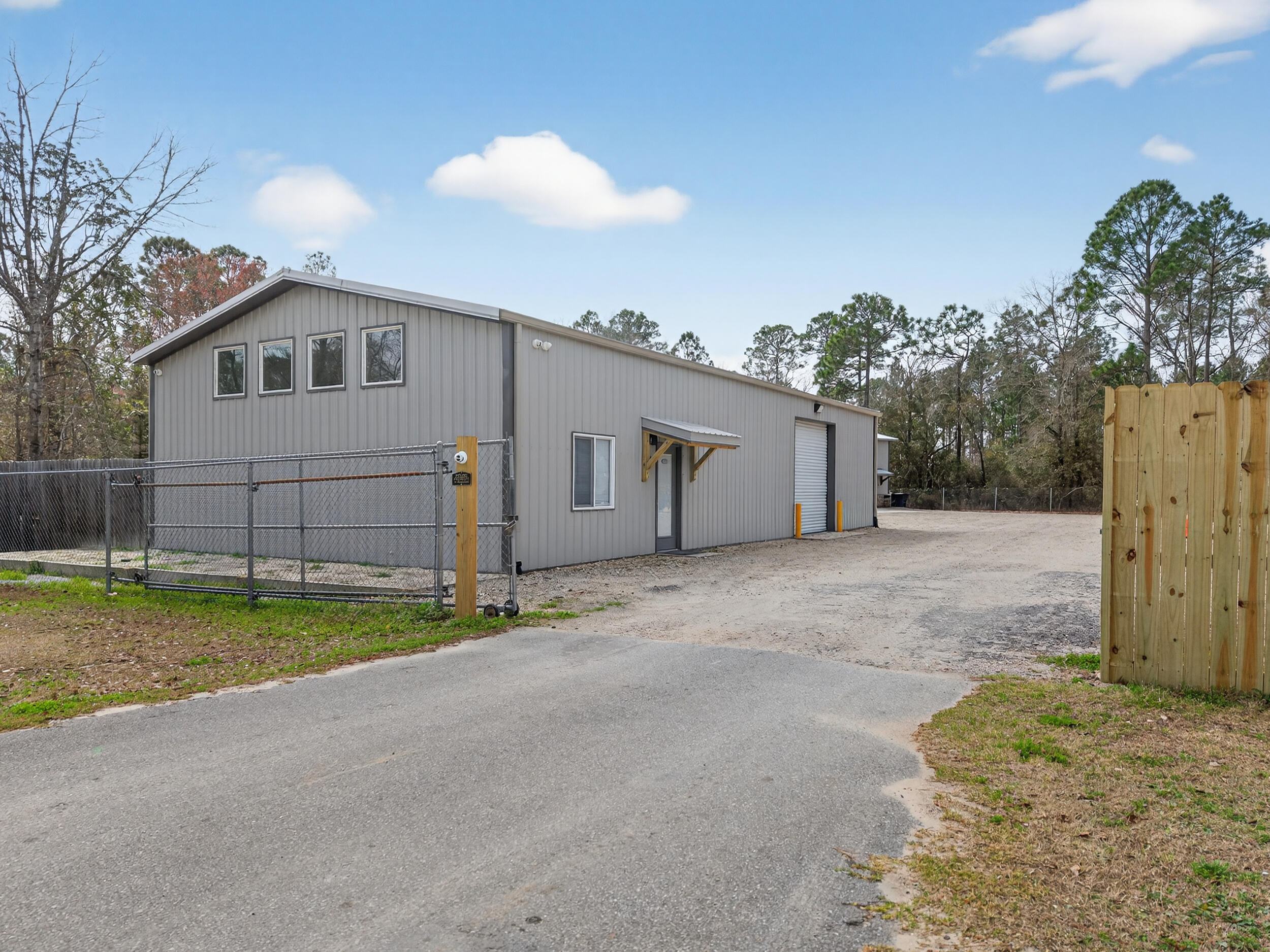 60 McDaniels Fishcamp Road, Unit A Freeport, FL 32439 - Photo 21 of 67 a view of a house with a yard and garage