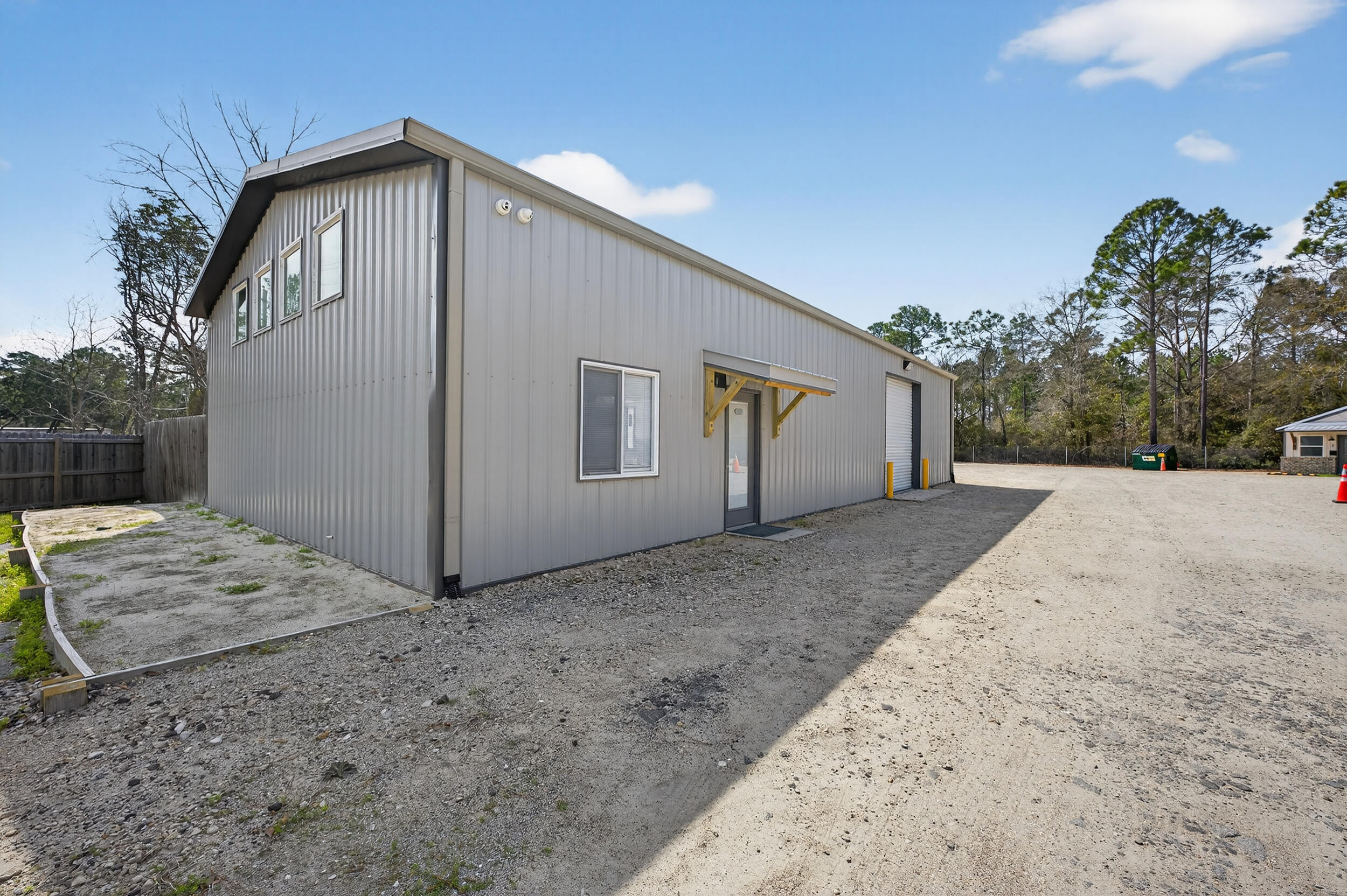 60 McDaniels Fishcamp Road, Unit A Freeport, FL 32439 - Photo 25 of 67 a front view of a house with a yard