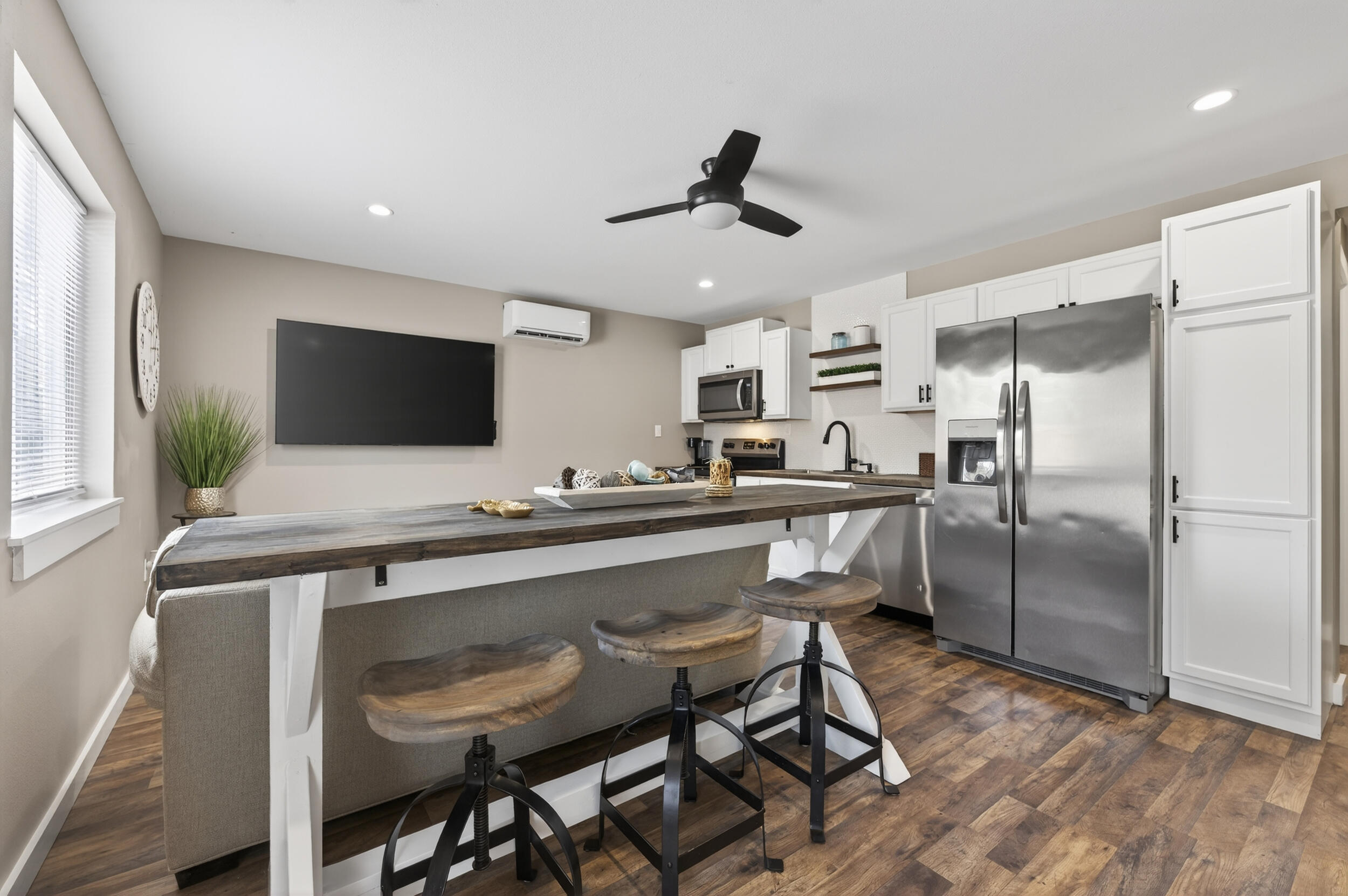 60 McDaniels Fishcamp Road, Unit A Freeport, FL 32439 - Photo 4 of 67 a kitchen with stainless steel appliances a table chairs refrigerator and microwave