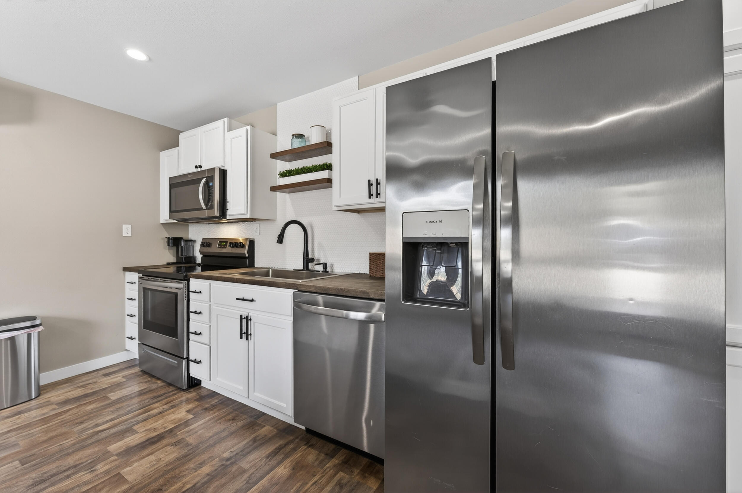 60 McDaniels Fishcamp Road, Unit A Freeport, FL 32439 - Photo 6 of 67 a kitchen with stainless steel appliances granite countertop a refrigerator a sink and white cabinets