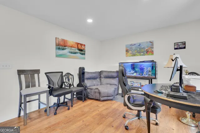 a living room with furniture a flat screen tv and a table