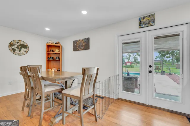 a view of a dining room with furniture and a floor to ceiling window