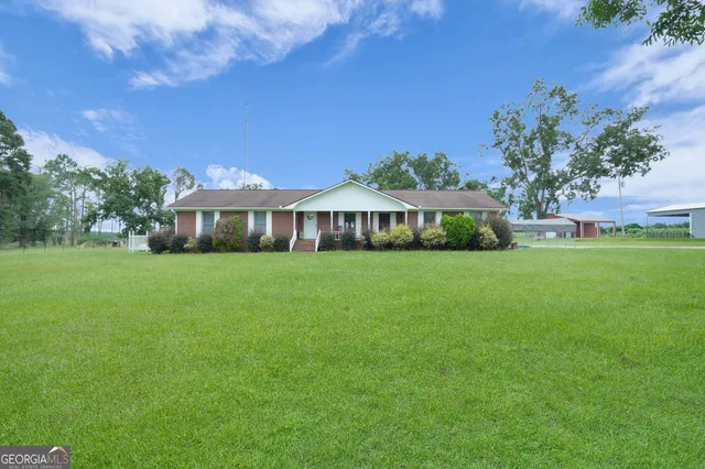 a front view of house with a garden
