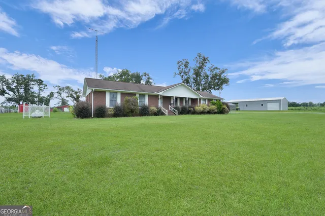 an aerial view of residential houses with outdoor space and city view