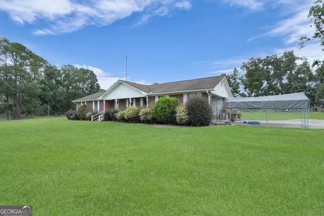 a front view of house with yard and green space