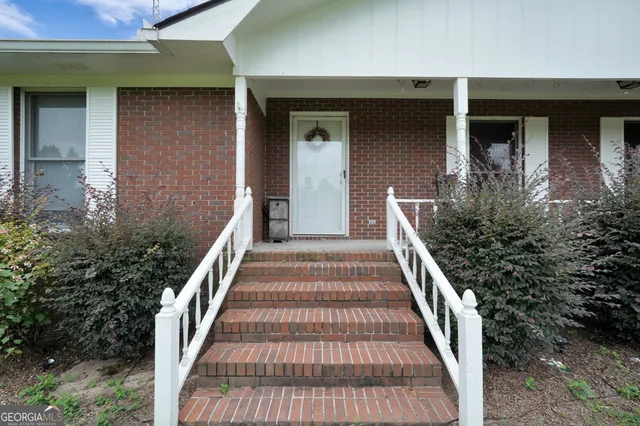a view of a house with wooden floor and a porch