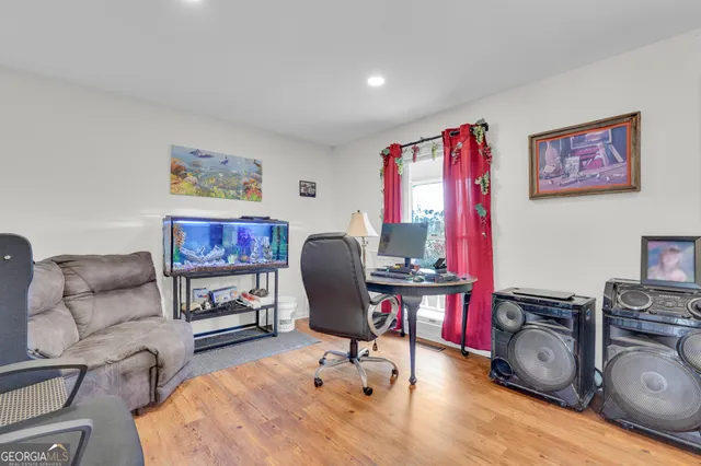 a view of a workspace with furniture and a flat screen tv