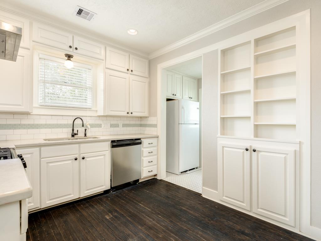 4528 Avenue R 1/2 Galveston, TX 77551 - Photo 15 of 22 a kitchen with white cabinets and sink