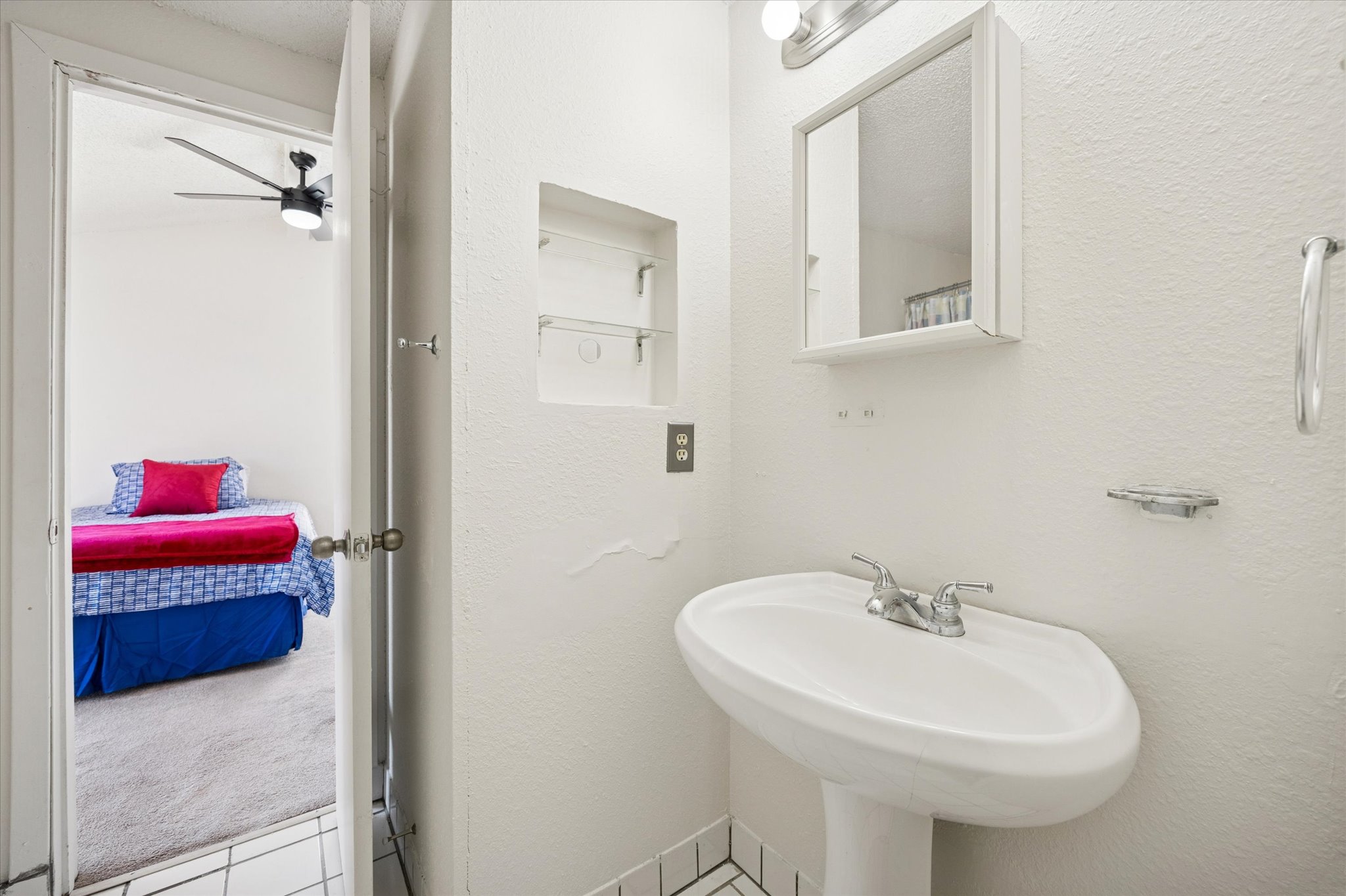 4814 Misty Slope Lane Austin, TX 78744 - Photo 12 of 17 a bathroom with a sink and a mirror