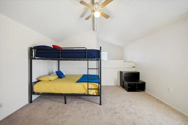 a bedroom with a bed and a table