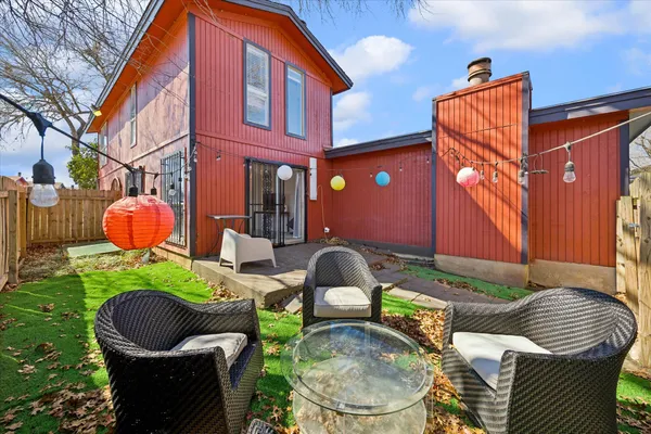 a backyard of a house with outdoor seating