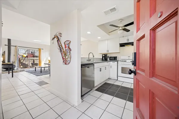 a kitchen with stainless steel appliances granite countertop a refrigerator and a sink
