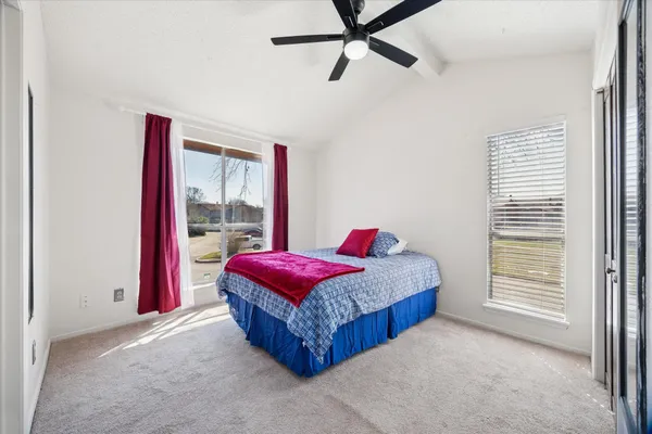 a living room with a bed and a window