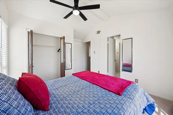 a bedroom with a bed and a closet