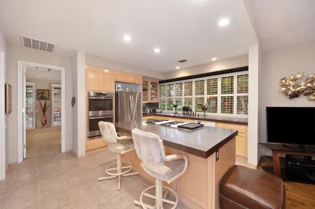 a living room with furniture large window and a fireplace