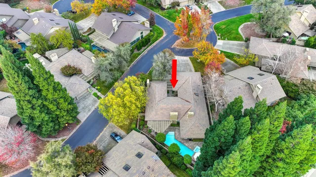 a view of a kitchen with kitchen island a counter top space a sink stainless steel appliances and cabinets