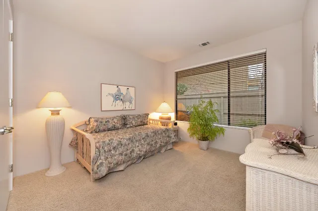 a bedroom with a bed and ceiling fan