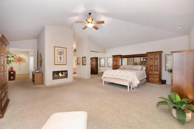 an aerial view of a house with a yard and greenery
