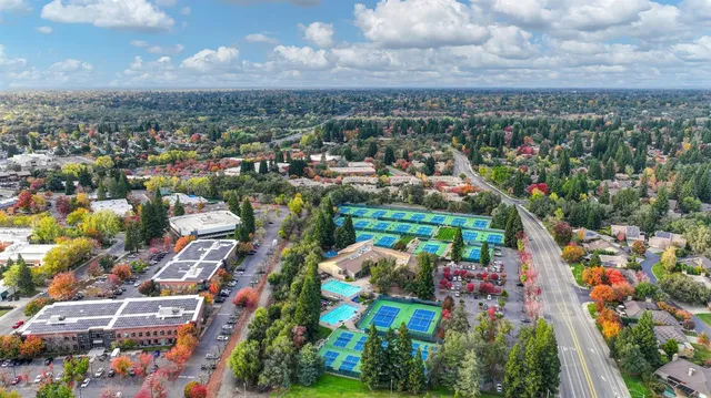 an aerial view of residential houses with outdoor space and street view