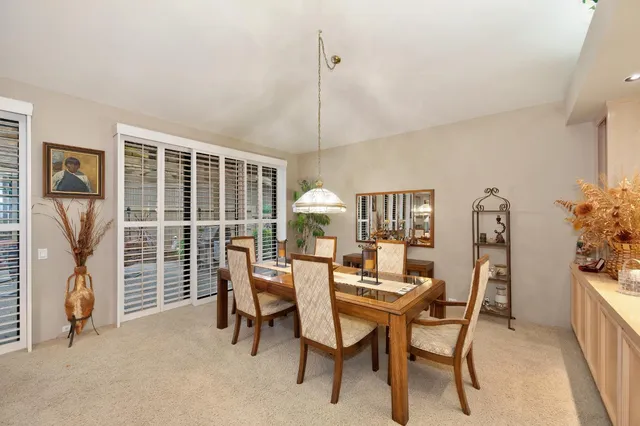 a view of a chair and table in backyard of the house