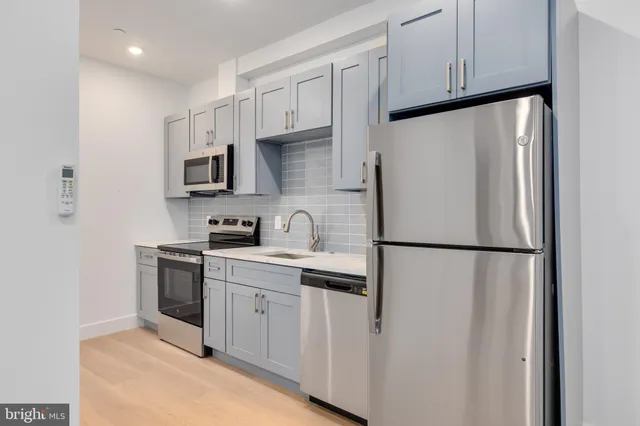 a white refrigerator freezer sitting inside of a kitchen