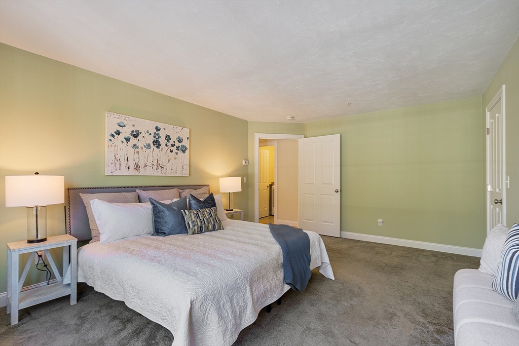 1148 Hill Road, Unit 1148 Boxborough, MA 01719 - Photo 14 of 31 a bedroom with a bed and lamp