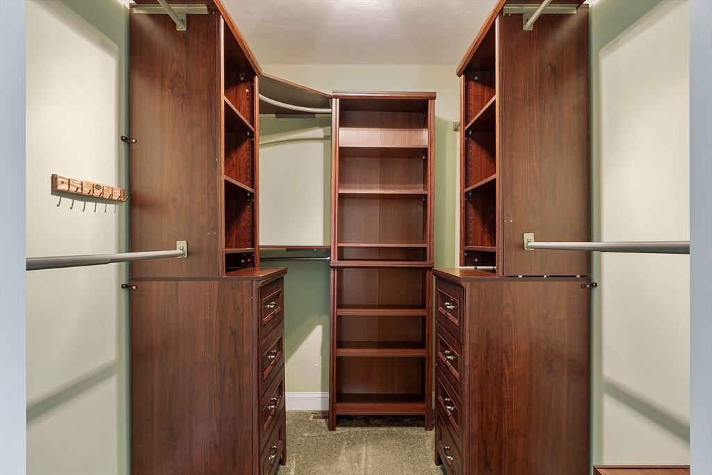 1148 Hill Road, Unit 1148 Boxborough, MA 01719 - Photo 15 of 31 a view of walk in closet with clothes and shoes