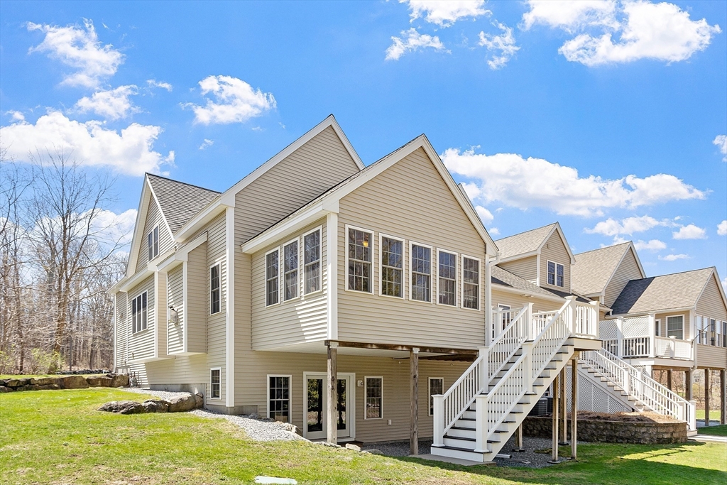 1148 Hill Road, Unit 1148 Boxborough, MA 01719 - Photo 27 of 31 a view of a house with a yard