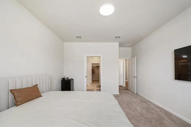 a bed room with a bed and a television