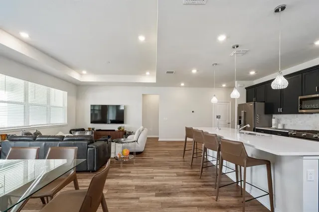 a large kitchen with a table and chairs