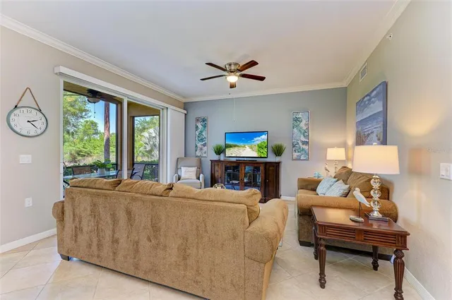 a living room with furniture a table and a large window