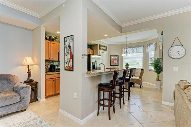 a dining hall with stainless steel appliances a dining table and chairs