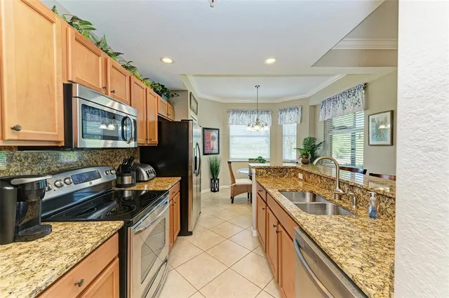 a kitchen with a sink refrigerator and stove