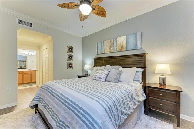 a bedroom with a large bed and a chandelier