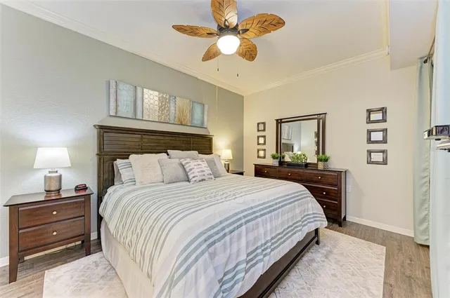 a bedroom with a large bed and a chandelier