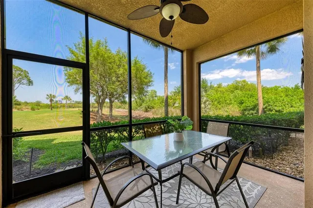 a view of a house with a yard and a pond