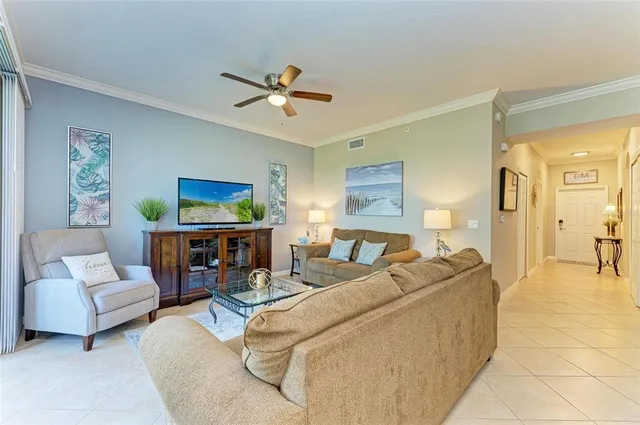 a kitchen with stainless steel appliances granite countertop a refrigerator a stove a sink a dining table and chairs with wooden floor