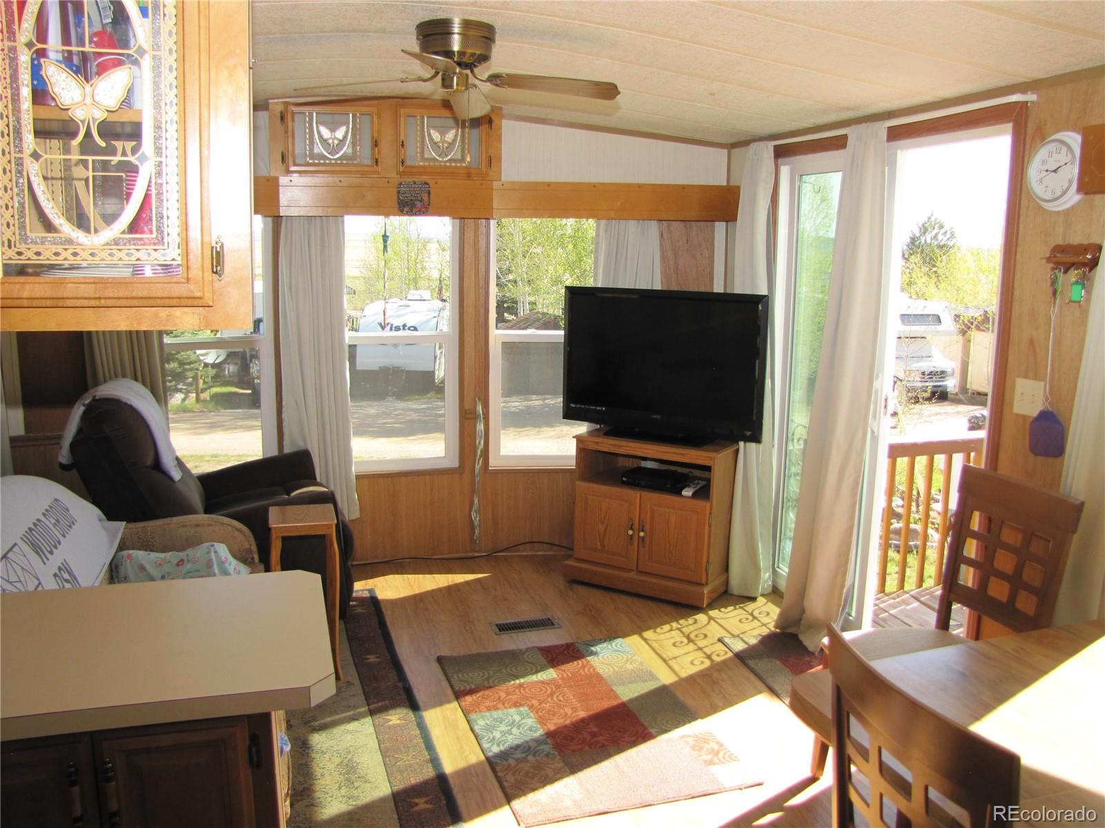 234 Smoke Stack Road Fairplay, CO 80440 - Photo 15 of 19 a living room with furniture a flat screen tv and a floor to ceiling window