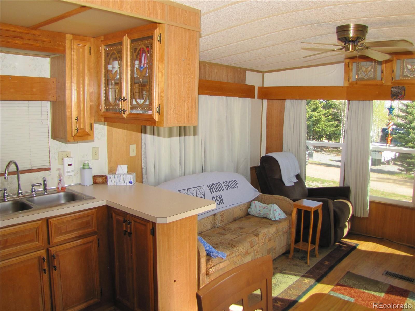 234 Smoke Stack Road Fairplay, CO 80440 - Photo 16 of 19 a kitchen with a sink a stove and a dining table with garden view