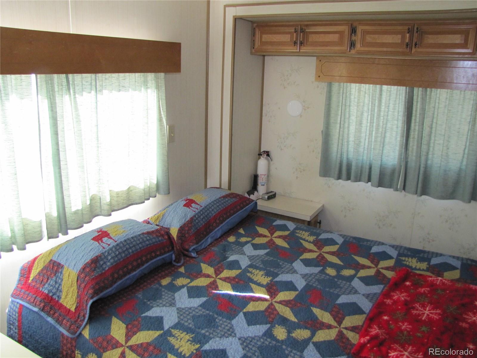 234 Smoke Stack Road Fairplay, CO 80440 - Photo 19 of 19 a bedroom with a bed and a window