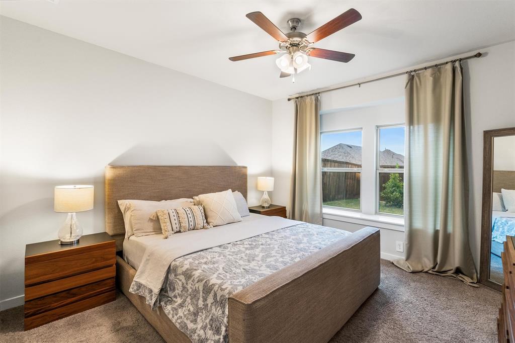2407 Neff Lane Forney, TX 75126 - Photo 8 of 22 a bedroom with a large bed and a window