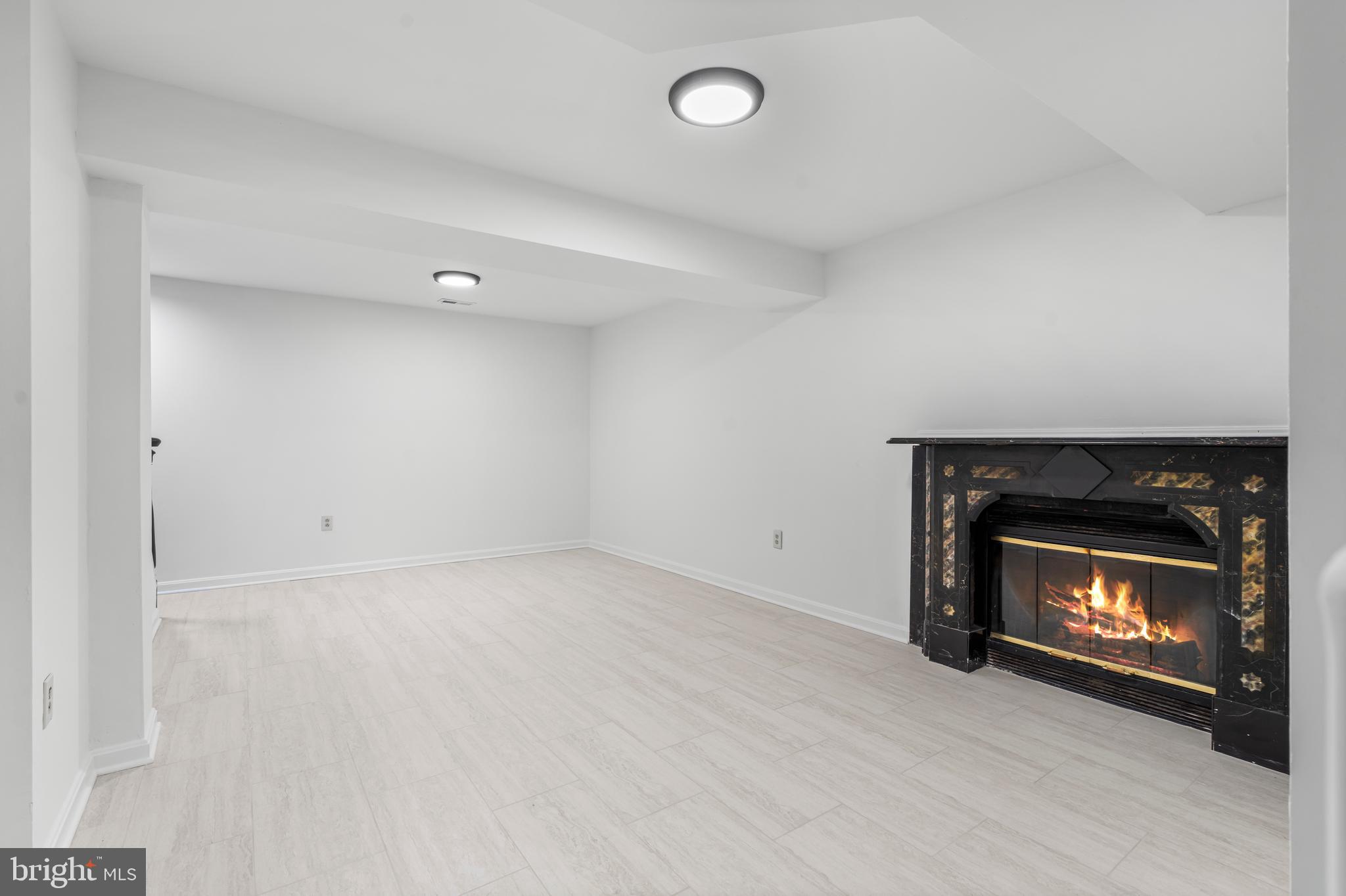 6416 Sherwood Road Baltimore, MD 21239 - Photo 25 of 43 a room with a fireplace