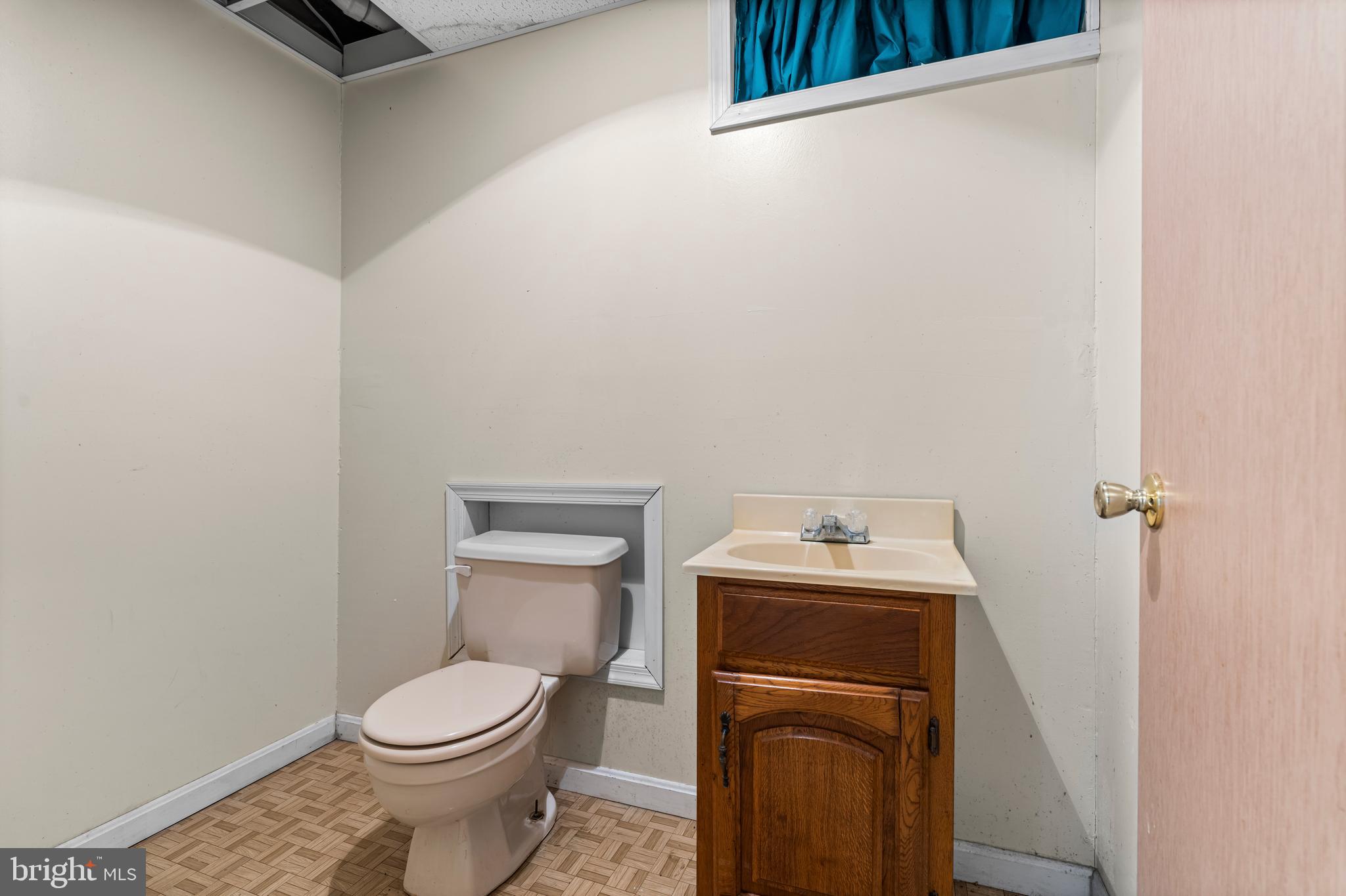 6416 Sherwood Road Baltimore, MD 21239 - Photo 27 of 43 a bathroom with a toilet a sink and a shower