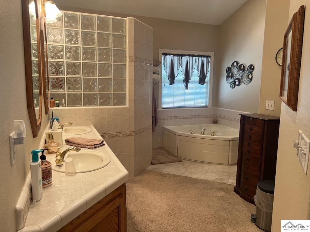 19740 Reeds Creek Road Red Bluff, CA 96080 - Photo 37 of 51 a bathroom with a granite countertop sink and a bathtub