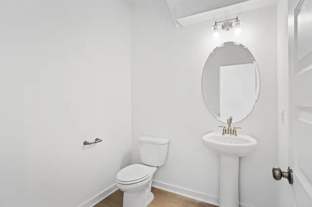 a bathroom with a sink toilet and a mirror