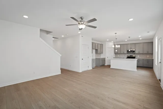 a view of a kitchen with a sink and a refrigerator
