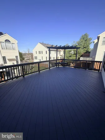 a view of a balcony with wooden floor and outdoor seating