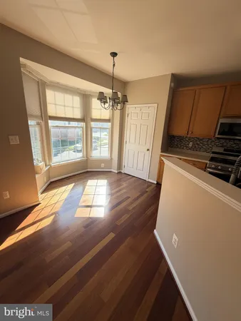 a view of a kitchen with wooden floor