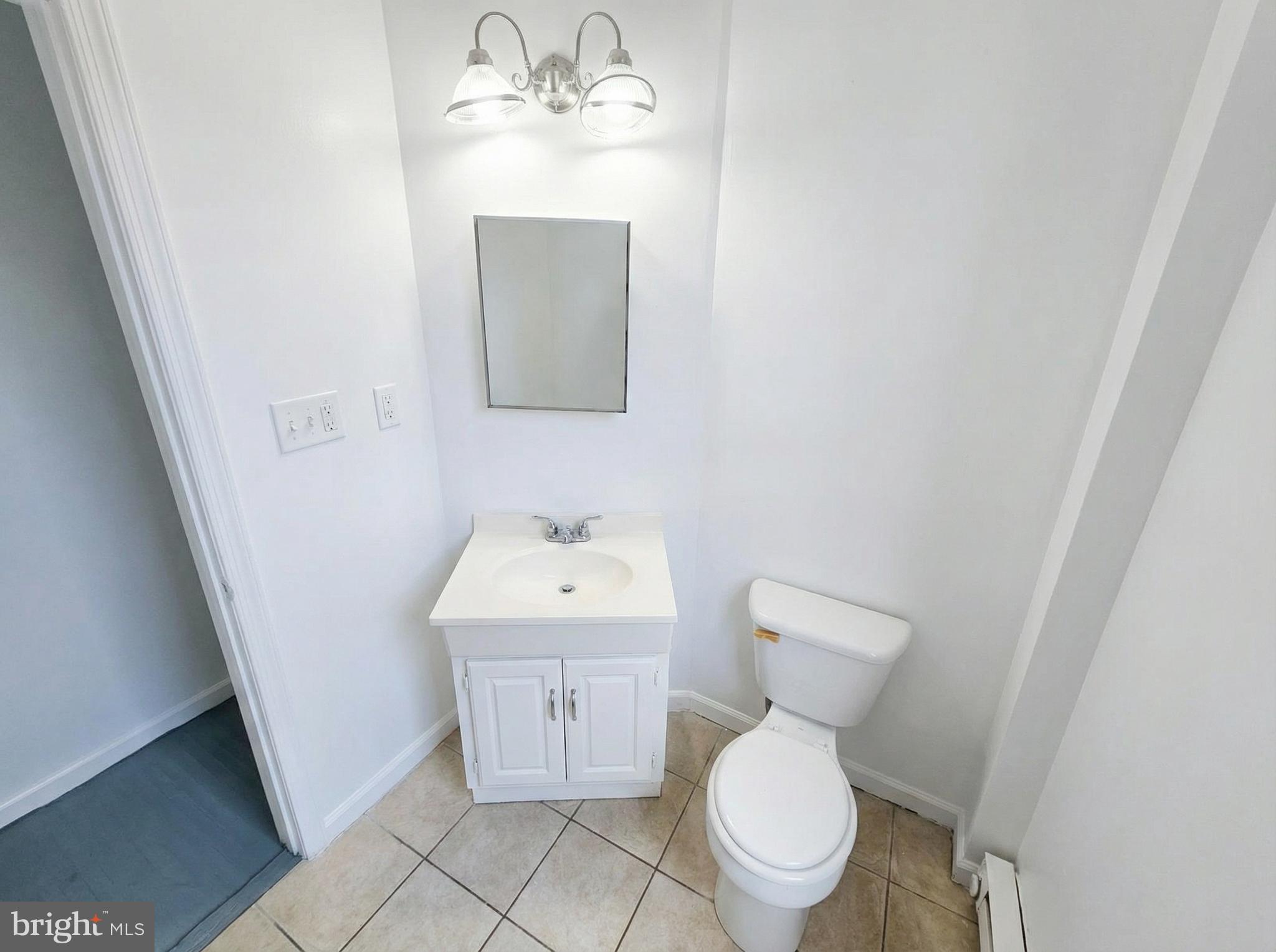 345 East Princess Street York, PA 17403 - Photo 5 of 14 a bathroom with a toilet sink and mirror