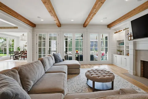 a kitchen with stainless steel appliances granite countertop a stove a refrigerator a kitchen island a table and chairs